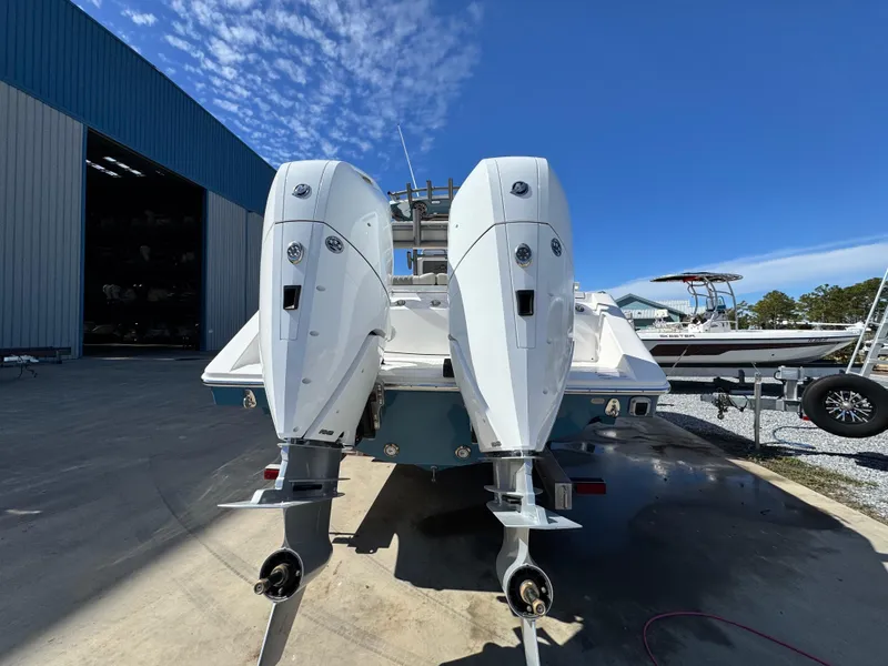 Slide: The Image of 2025 Solace 32 CS boat with dual outboard engines in a marina setting. - 5