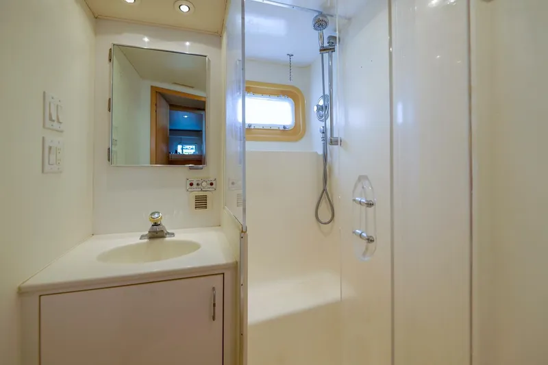 Slide: The Image of Bathroom interior of 1998 Hatteras 52 Sport Deck Motor Yacht, featuring shower and sink. - 10