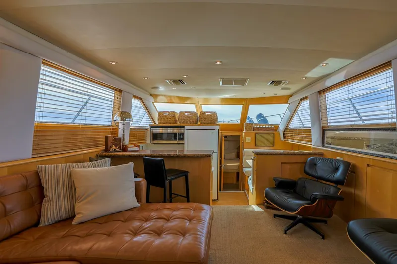 Slide: The Image of Interior of 1998 Hatteras 52 Sport Deck Motor Yacht, featuring luxurious seating and modern amenities. - 11