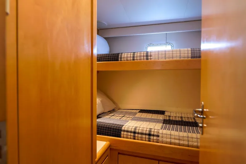 Slide: The Image of Bunk beds in 1998 Hatteras 52 Sport Deck Motor Yacht cabin, featuring wooden interior. - 12