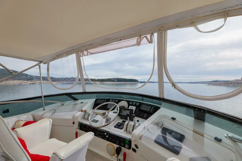 Slide: The Image of 1998 Hatteras 52 Sport Deck Motor Yacht helm with scenic ocean view. - 20