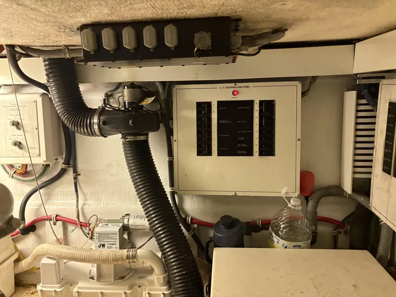 Slide: The Image of Engine room of 1998 Hatteras 52 Sport Deck Motor Yacht with control panels and wiring. - 25