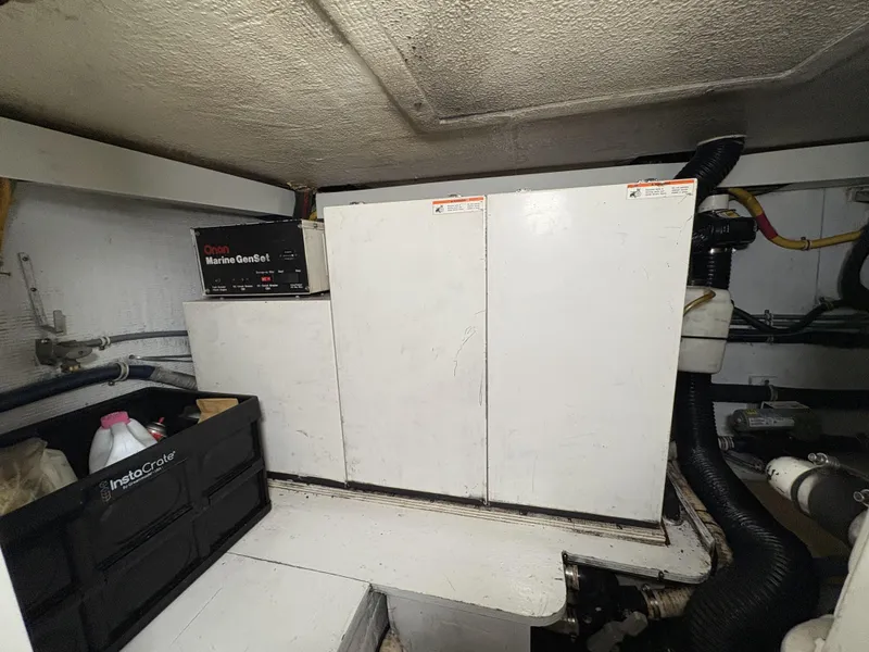 Slide: The Image of Engine room of 1998 Hatteras 52 Sport Deck Motor Yacht with equipment and storage. - 28