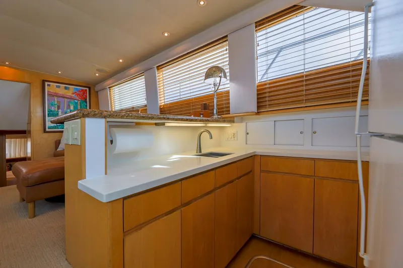 Slide: The Image of Interior of 1998 Hatteras 52 Sport Deck Motor Yacht kitchen with wooden cabinets and modern fixtures. - 3