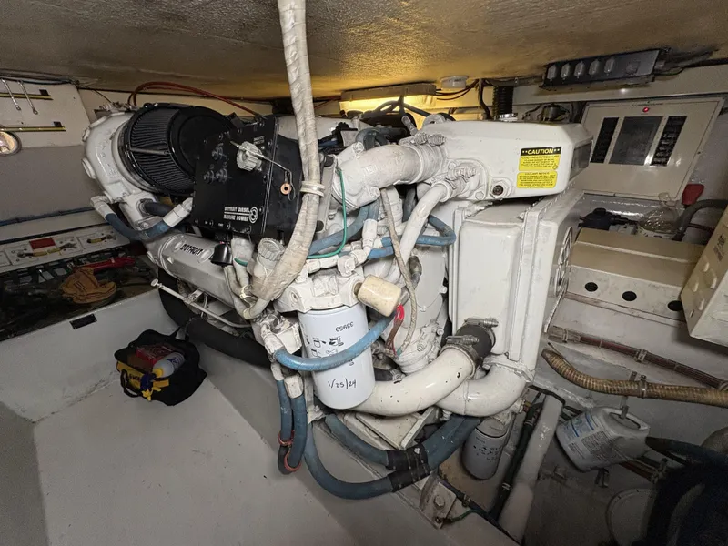 Slide: The Image of Engine room of 1998 Hatteras 52 Sport Deck Motor Yacht, showcasing mechanical components. - 30