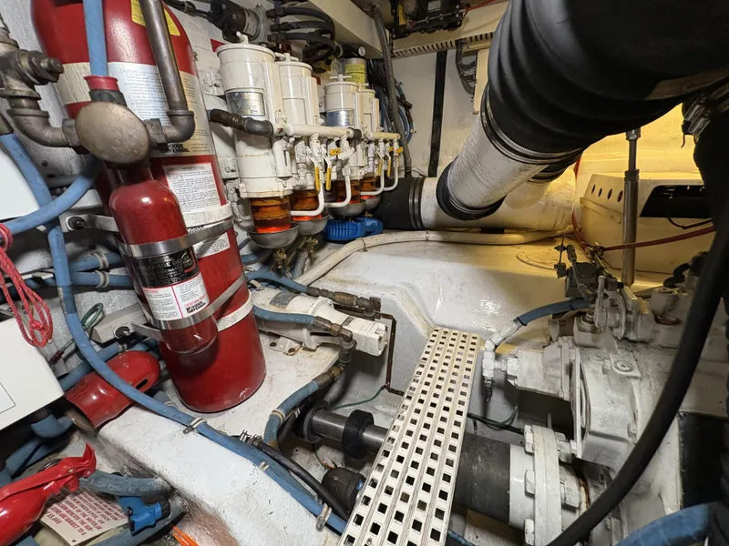 Slide: The Image of Engine room of 1998 Hatteras 52 Sport Deck Motor Yacht with fire extinguisher and fuel filters. - 36