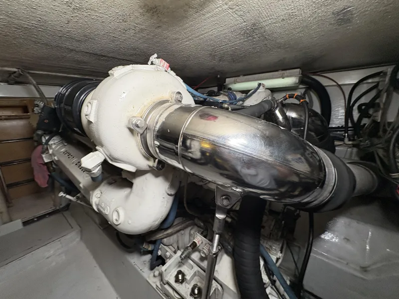 Slide: The Image of Engine room of 1998 Hatteras 52 Sport Deck Motor Yacht, showcasing mechanical components. - 38