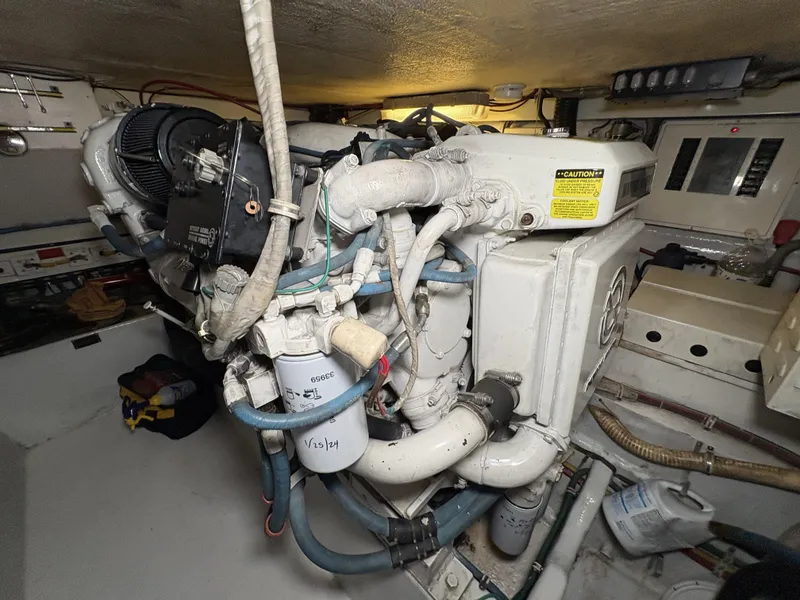 Slide: The Image of Engine room of 1998 Hatteras 52 Sport Deck Motor Yacht, showcasing mechanical components. - 39