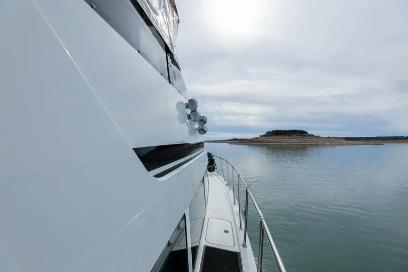 Slide: The Image of 1998 Hatteras 52 Sport Deck Motor Yacht cruising on calm waters. - 40