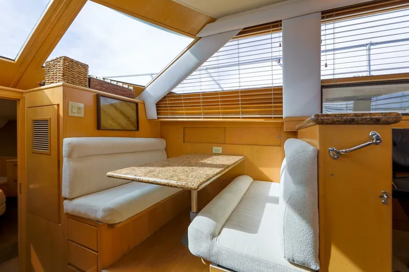 Slide: The Image of Interior of 1998 Hatteras 52 Sport Deck Motor Yacht with cozy dining area. - 5