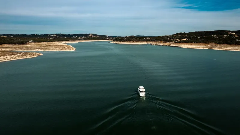 Slide: The Image of Aerial view of 1998 Hatteras 52 Sport Deck Motor Yacht on a serene lake. - 62