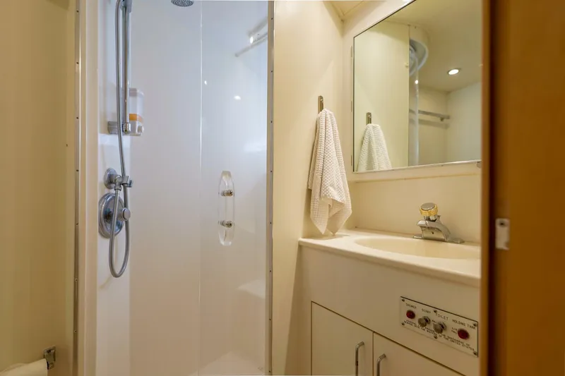Slide: The Image of Bathroom interior of 1998 Hatteras 52 Sport Deck Motor Yacht, featuring shower and sink. - 7