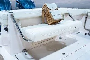 Slide: The Image of 2026 Grady-White Canyon 326 boat with white seating and a wicker basket. - 11