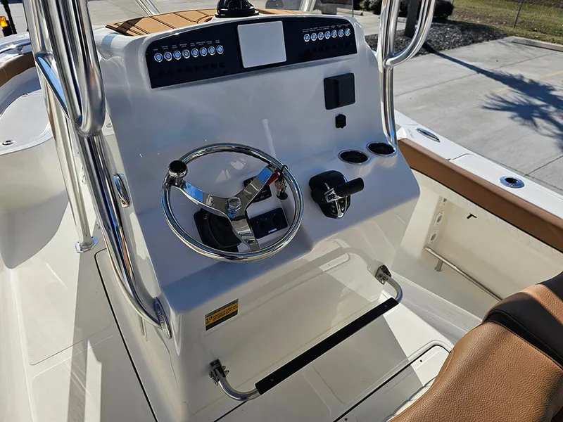 Slide: The Image of 2025 Pioneer 222 Sportfish boat console with steering wheel and controls. - 15