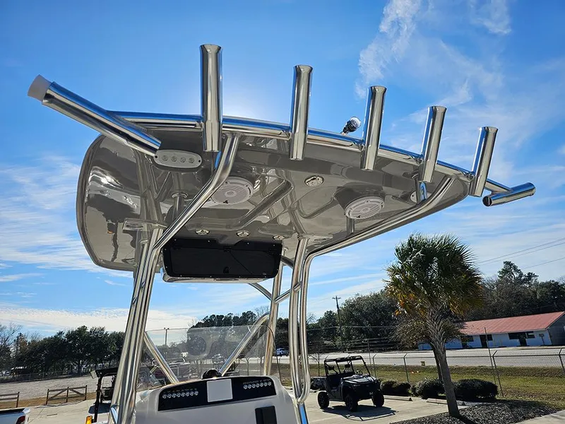 Slide: The Image of 2025 Pioneer 222 Sportfish boat with T-top and rod holders under a clear blue sky. - 18
