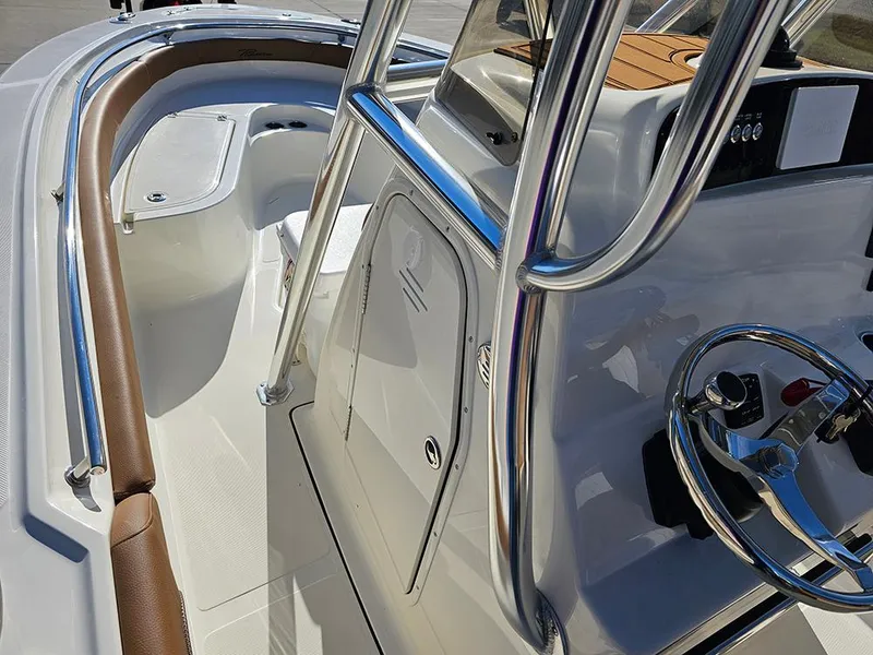 Slide: The Image of 2025 Pioneer 222 Sportfish boat interior with steering wheel and seating area. - 19