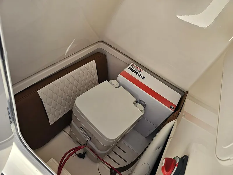 Slide: The Image of 2025 Pioneer 222 Sportfish interior storage with portable toilet and propeller box. - 21