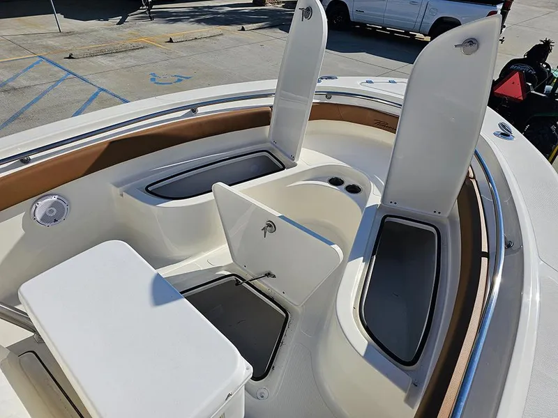 Slide: The Image of 2025 Pioneer 222 Sportfish boat interior with open storage compartments and seating. - 23
