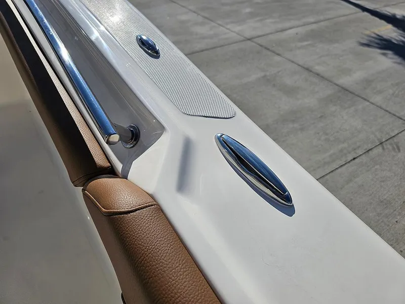 Slide: The Image of 2025 Pioneer 222 Sportfish boat detail with chrome fittings and brown upholstery. - 26