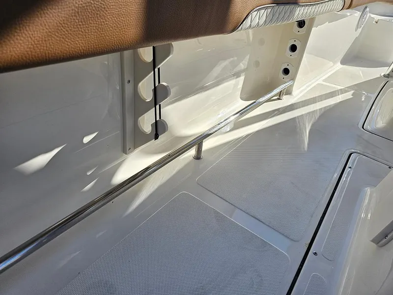 Slide: The Image of 2025 Pioneer 222 Sportfish boat interior with rod holders and non-slip flooring. - 28
