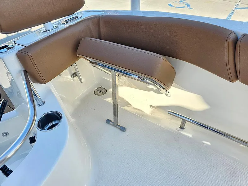 Slide: The Image of 2025 Pioneer 222 Sportfish boat interior with brown seating and stainless steel fixtures. - 29