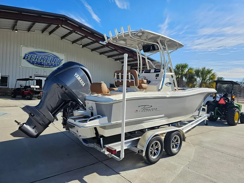 Slide: The Image of 2025 Pioneer 222 Sportfish boat on trailer with Yamaha outboard motor, parked outside a building. - 3