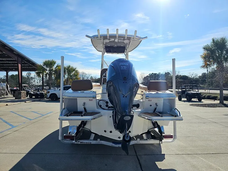 Slide: The Image of 2025 Pioneer 222 Sportfish boat with powerful outboard motor, parked outdoors under clear sky. - 8