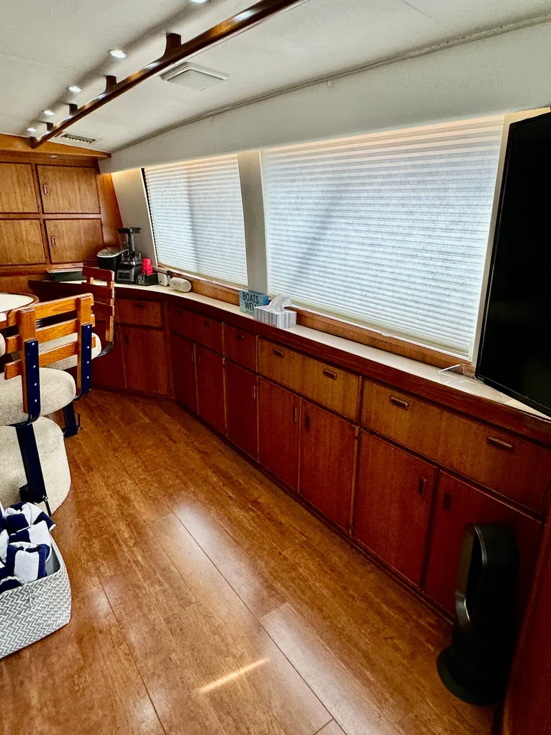 Slide: The Image of Interior of a 1982 Bertram 54 Convertible yacht with wooden cabinetry and seating. - 13
