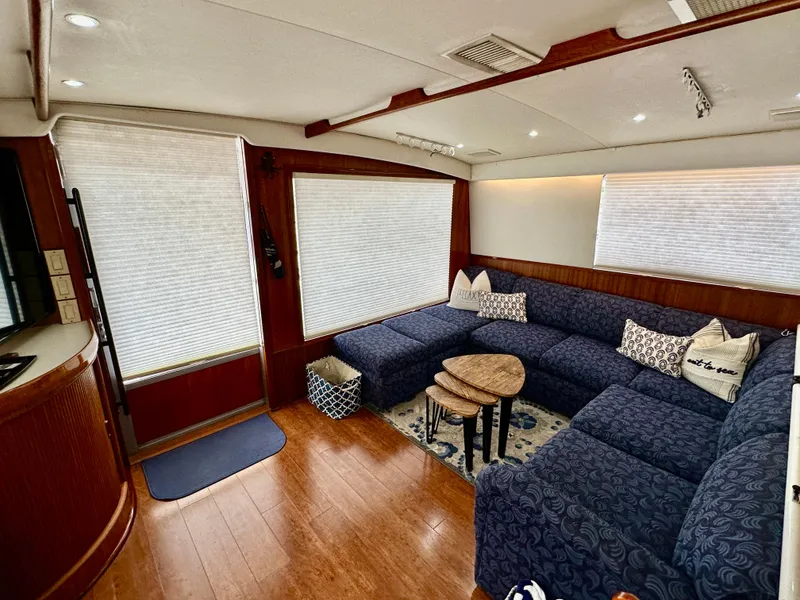 Slide: The Image of Interior of 1982 Bertram 54 Convertible yacht with plush seating and wooden flooring. - 15