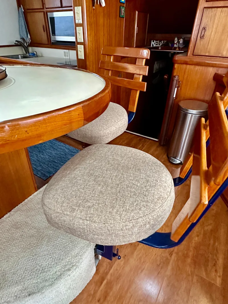 Slide: The Image of Interior of 1982 Bertram 54 Convertible yacht with wooden furnishings and cushioned seating. - 18
