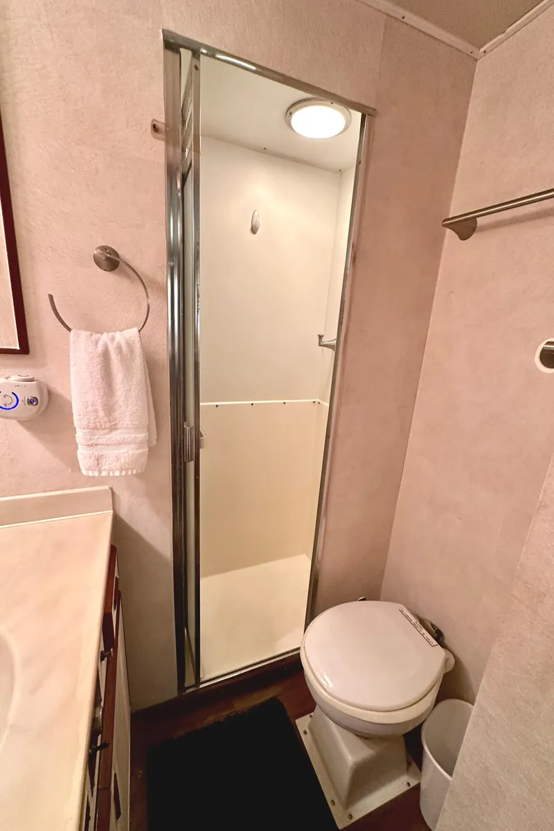 Slide: The Image of 1982 Bertram 54 Convertible yacht bathroom with shower, toilet, and towel rack. - 36