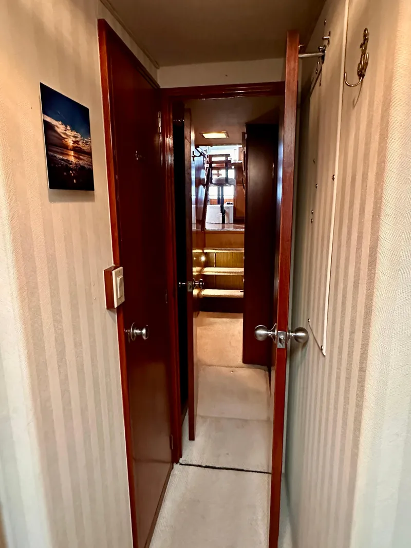 Slide: The Image of Interior hallway of 1982 Bertram 54 Convertible yacht with wooden doors and beige walls. - 39