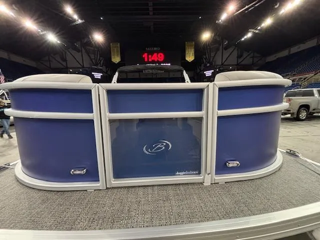 Slide: The Image of 2025 Barletta ARIA 20QC pontoon boat displayed indoors with blue paneling. - 3