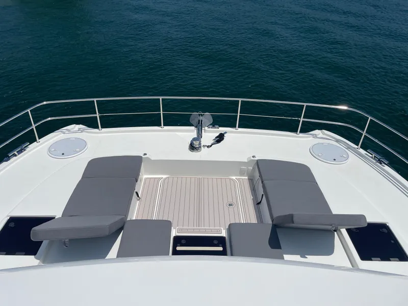 Slide: The Image of Fountaine Pajot MY 44 2020 yacht deck with cushioned seating and ocean view. - 19