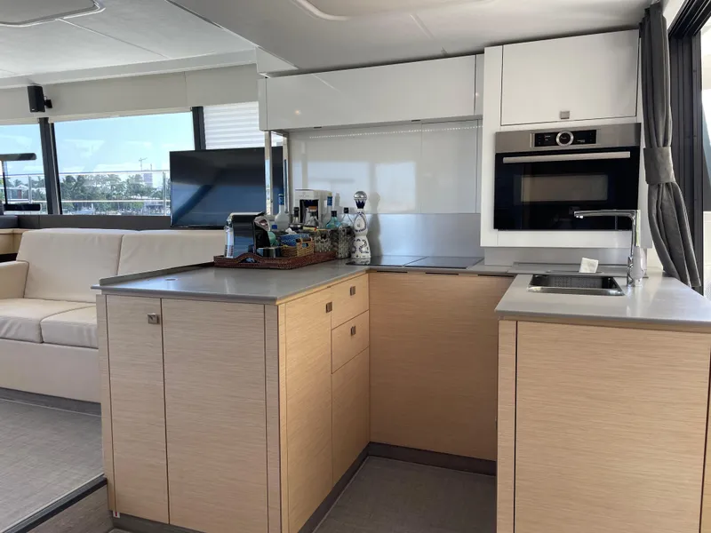 Slide: The Image of Modern kitchen interior on 2020 Fountaine Pajot MY 44 yacht, featuring sleek cabinetry and appliances. - 30
