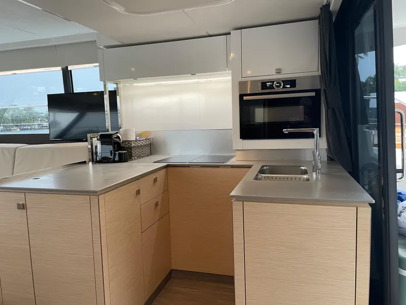 Slide: The Image of Modern kitchen interior on 2020 Fountaine Pajot MY 44 yacht, featuring sleek cabinetry and appliances. - 35