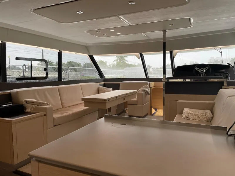 Slide: The Image of Luxurious interior of 2020 Fountaine Pajot MY 44 yacht with modern seating and panoramic windows. - 36