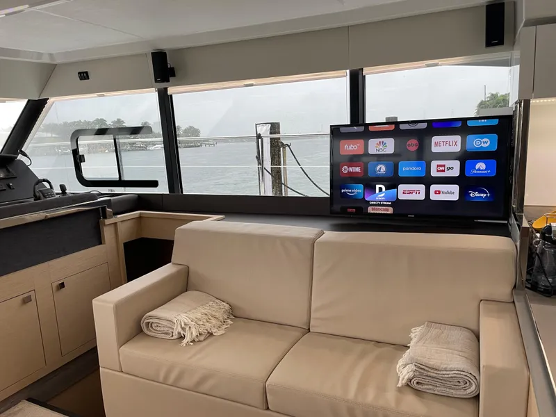Slide: The Image of Interior of 2020 Fountaine Pajot MY 44 yacht with TV and beige seating. - 37