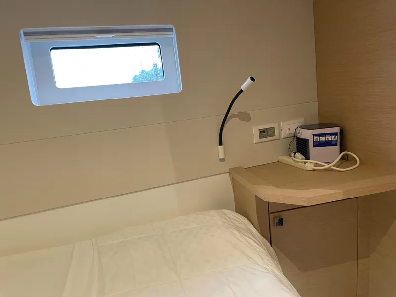 Slide: The Image of Cozy cabin interior of 2020 Fountaine Pajot MY 44 yacht with window and bedside lamp. - 44