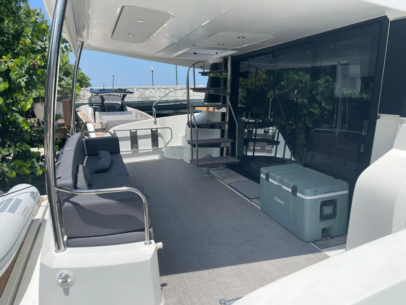 Slide: The Image of 2020 Fountaine Pajot MY 44 yacht deck with seating and cooler. - 9