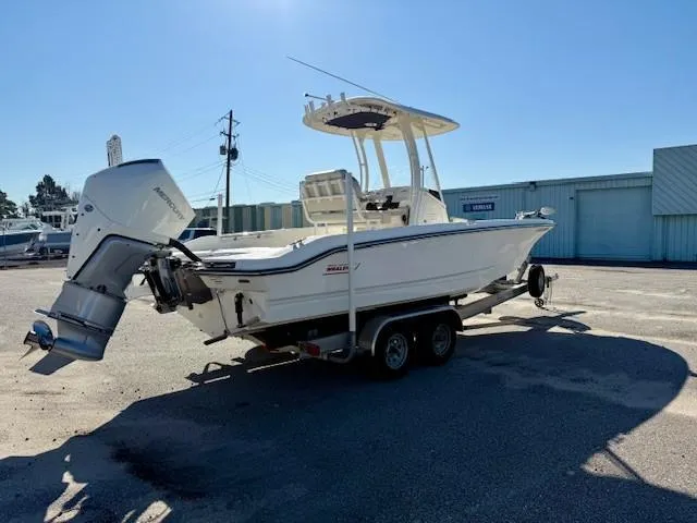 Slide: The Image of 2023 Boston Whaler 250 Dauntless boat on trailer, parked outdoors under clear sky. - 3