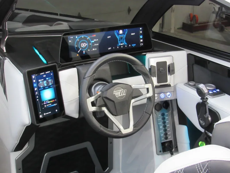 Slide: The Image of Futuristic 2025 Malibu M230 boat dashboard with digital displays and modern steering wheel. - 10