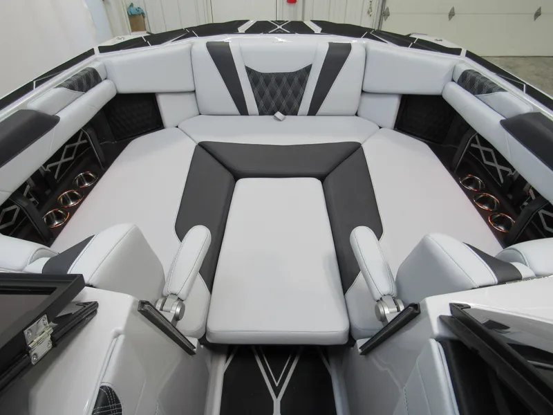 Slide: The Image of 2025 Malibu M230 boat interior with sleek white and black seating design. - 14