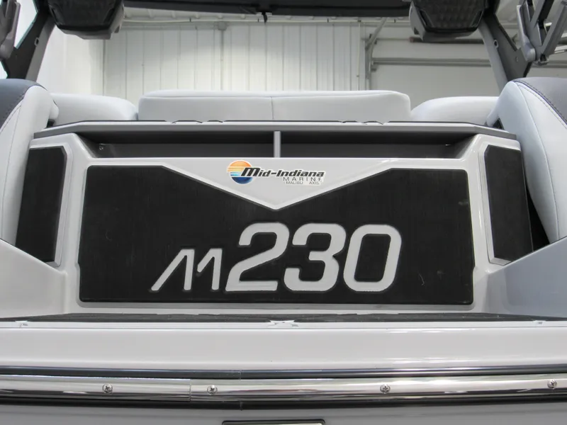 Slide: The Image of 2025 Malibu M230 boat interior with Mid-Indiana Marine logo, showcasing sleek design. - 20