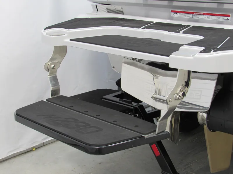 Slide: The Image of 2025 Malibu M230 boat swim platform with foldable step, featuring sleek design and durable materials. - 4