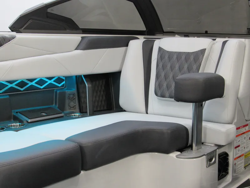 Slide: The Image of 2025 Malibu M230 boat interior with modern seating and ambient lighting. - 7