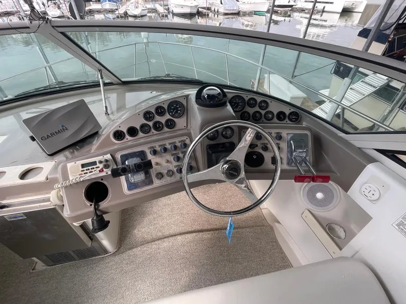 Slide: The Image of 2002 Carver 350 Mariner helm with steering wheel, controls, and Garmin navigation system. - 10