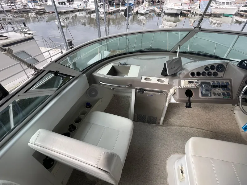 Slide: The Image of Interior view of 2002 Carver 350 Mariner yacht cockpit with marina background. - 11