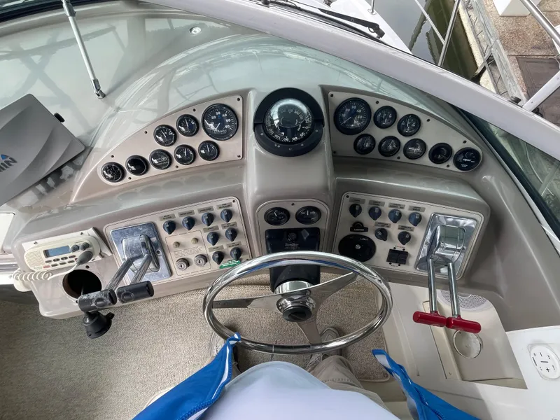 Slide: The Image of Control panel of a 2002 Carver 350 Mariner boat with steering wheel and gauges. - 16