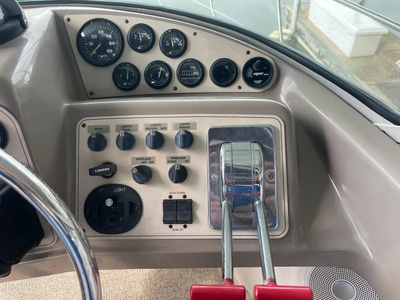 Slide: The Image of Control panel of 2002 Carver 350 Mariner boat with gauges and throttle levers. - 17